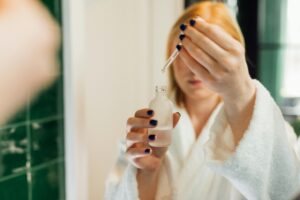 Reflection-of-a-Woman-Holding-a-Bottle-of-Serum